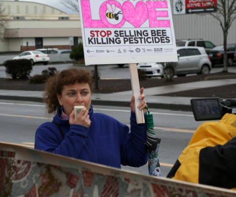 Lisa Arkin holds a sign at a protest.