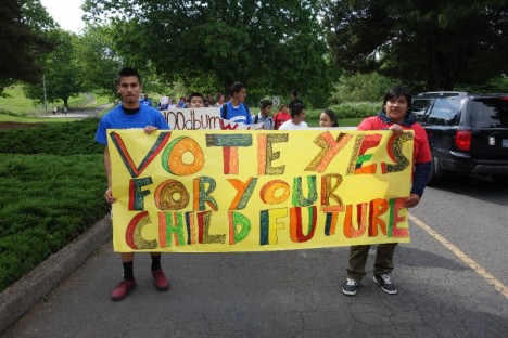 Young activists hold a sign during a protest.