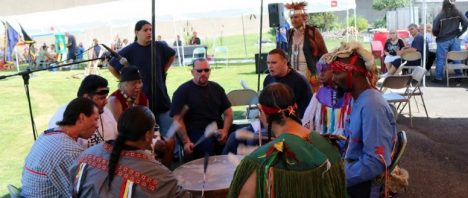 Members of the Lakota Oyate Ki Club at the Oregon State Penitentiary sitting around a drum circle.