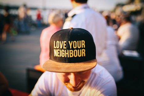 Picture of a person wearing a hat that reads: Love Your Neighbor